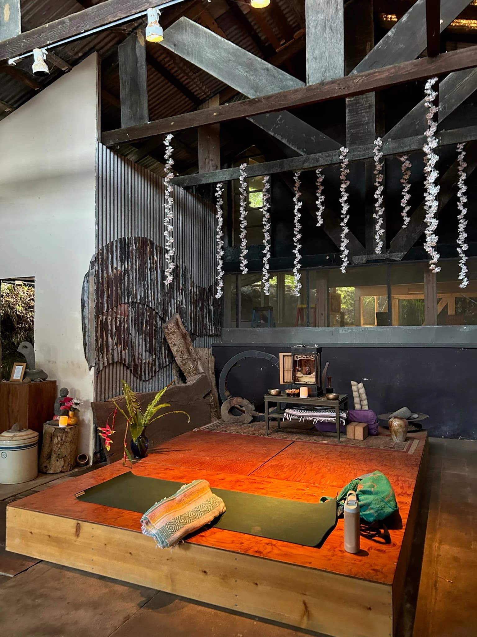 Teaching area of the yoga studio looking out toward the tropical gardens